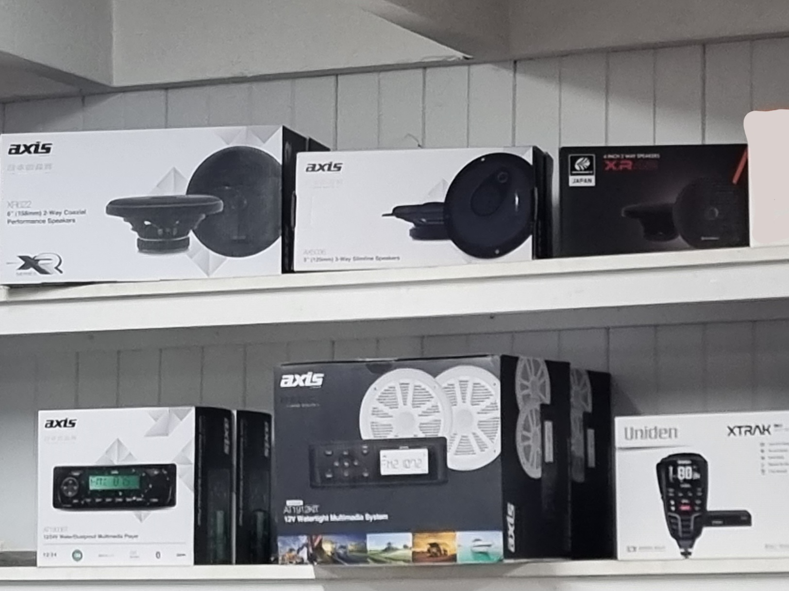 Car audio stock on the shelf: Axis speakers, head units and a 12 volt waterproof multimedia system